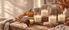 fall collection on candle and pumpkin candle on wooden table